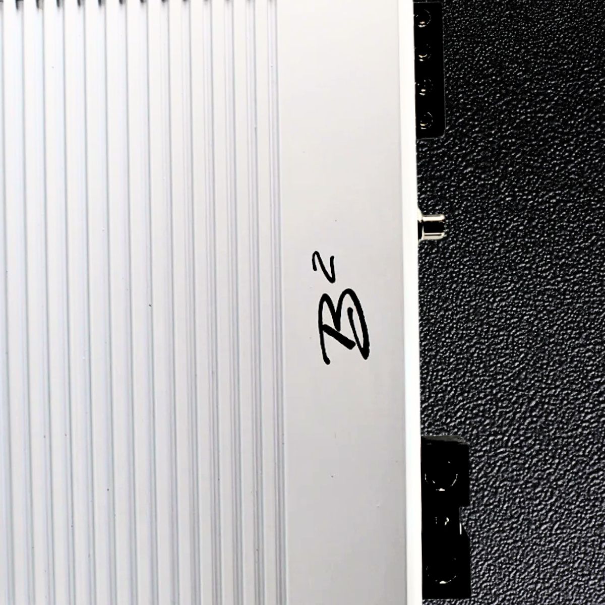Amplifier Category Background. White B2 audio Amplifier zoomed in so it fills 3/4 of the left side of image on a shiny black premium leather background image.