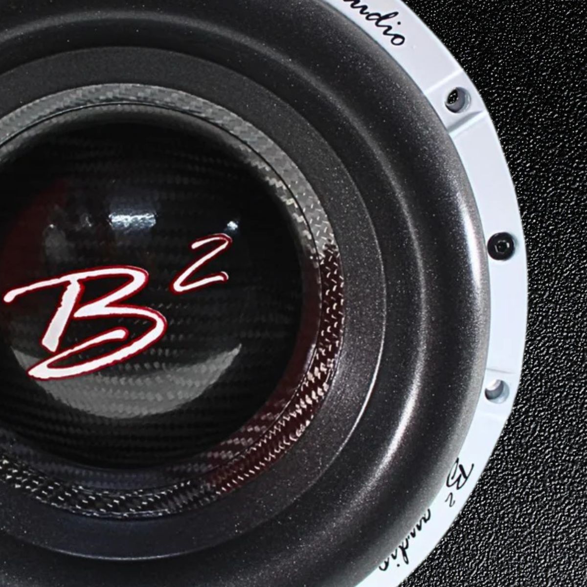 B2 Audio Subwoofer zoomed in on the front so it fills 3/4 of the left side of image on a shiny black premium leather background image.
