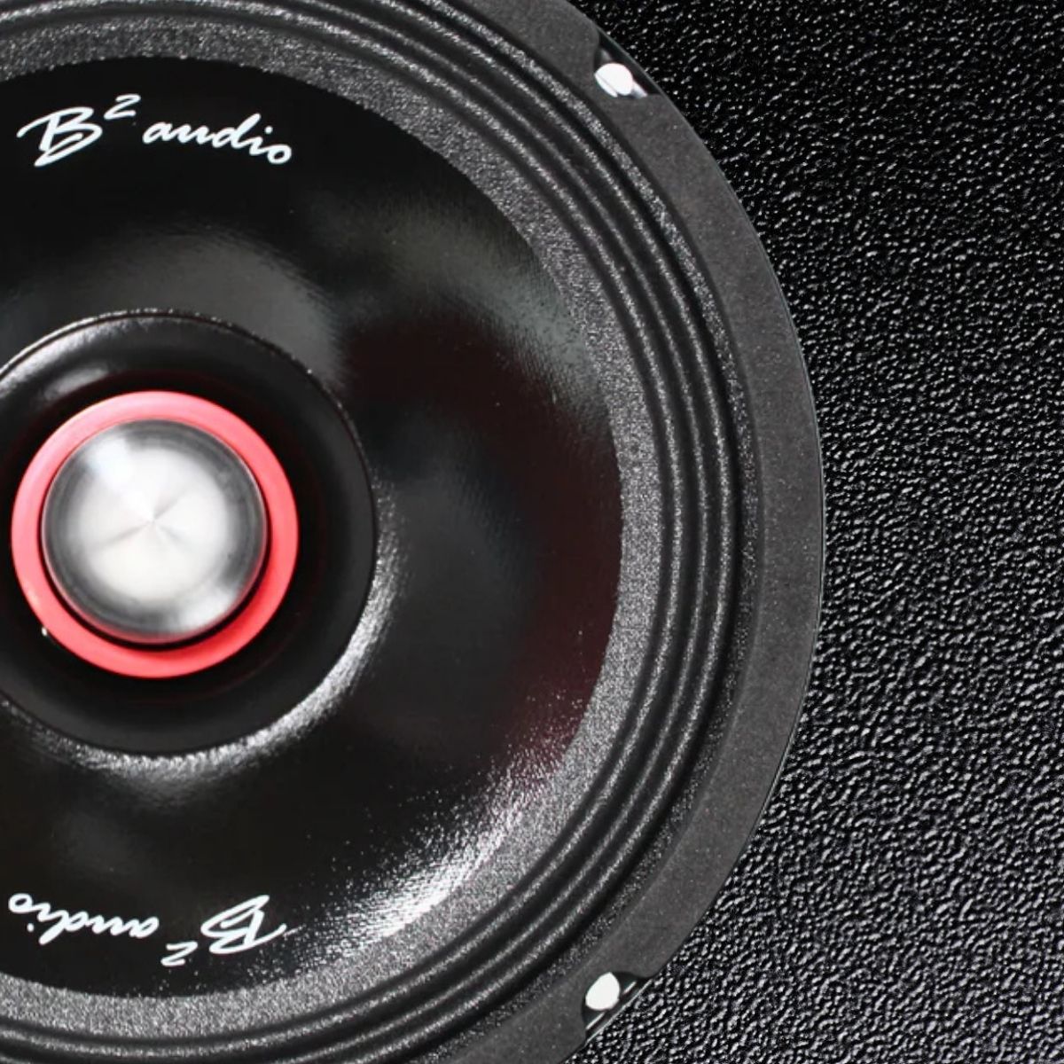 Loud Speaker 6P zoomed in so it fills 3/4 of the left side of image on a shiny black premium leather textured background image.